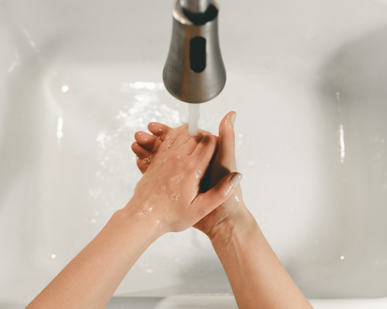 Person washing hands to prevent spread of germs