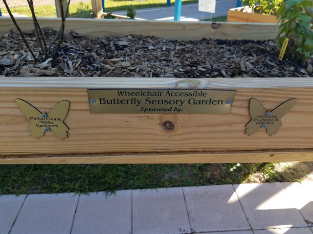 Wooden flower box with plaque stating 